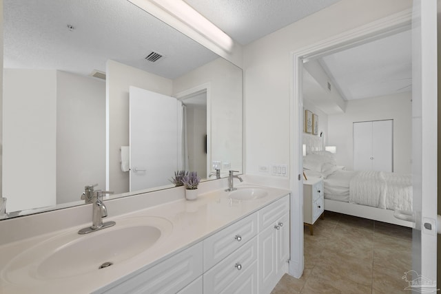 8501 Gulf Blvd Unit 3B, Navarre Beach, FL 32566 - bathroom featuring ensuite bathroom, double vanity, and a textured ceiling