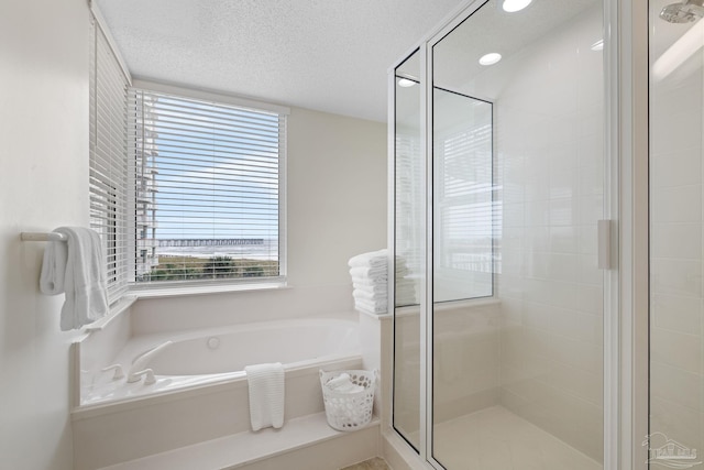 8501 Gulf Blvd Unit 3B, Navarre Beach, FL 32566 - full bathroom with a bath, a stall shower, and a textured ceiling
