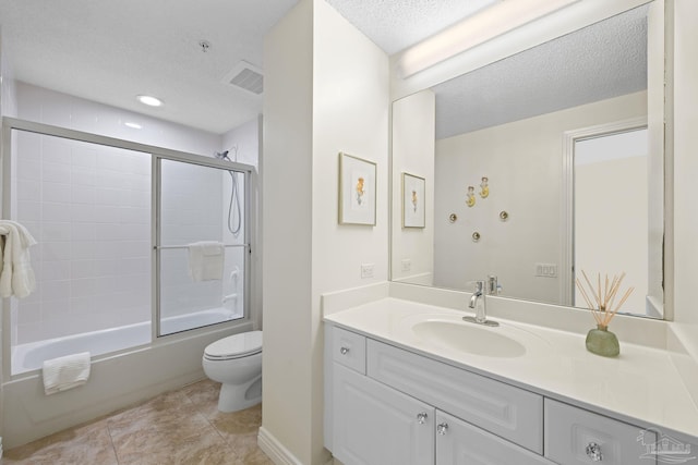8501 Gulf Blvd Unit 3B, Navarre Beach, FL 32566 - bathroom featuring a textured ceiling, toilet, vanity, and shower / bath combination with glass door
