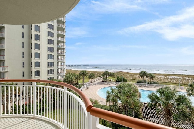 balcony with a view of the beach and a water view