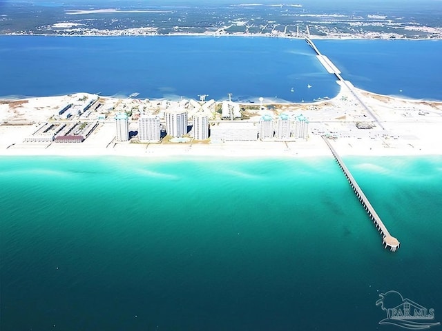 birds eye view of property with a beach view and a water view