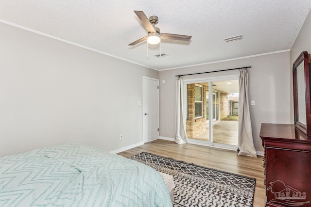 bedroom with access to outside, crown molding, visible vents, and wood finished floors