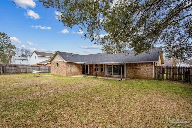 back of property featuring a patio area, brick siding, a lawn, and a fenced backyard