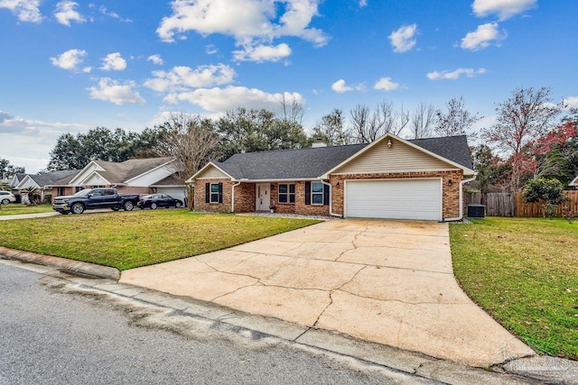 ranch-style house with central AC, brick siding, fence, concrete driveway, and a front yard