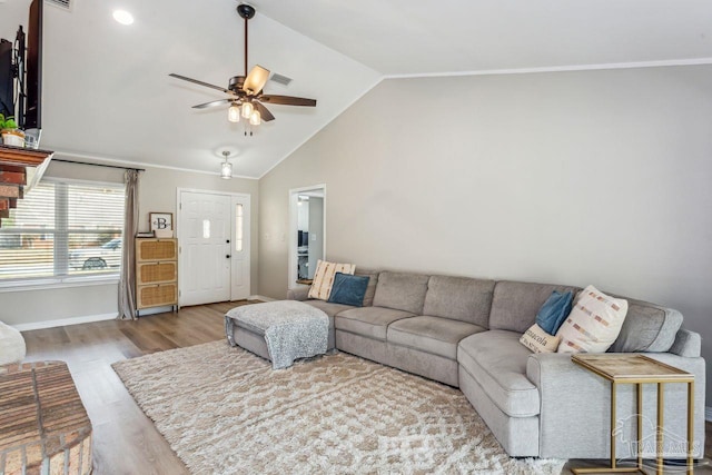 living room featuring baseboards, visible vents, a ceiling fan, wood finished floors, and vaulted ceiling