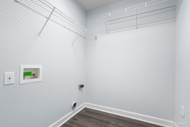 clothes washing area featuring dark wood-style floors, washer hookup, baseboards, and laundry area