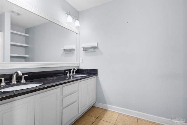 full bath with tile patterned flooring, baseboards, a sink, and visible vents