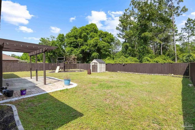 view of yard with a fenced backyard, a playground, a patio area, and a storage shed