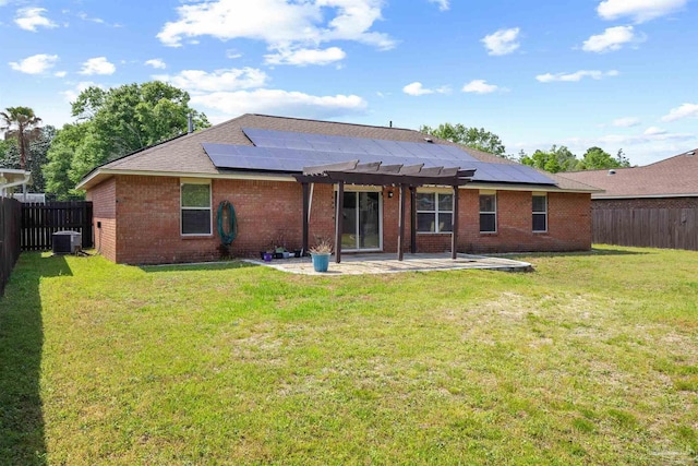 back of house featuring a pergola, a patio area, cooling unit, solar panels, and brick siding