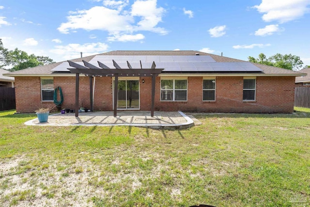 rear view of house featuring a patio, a pergola, and solar panels