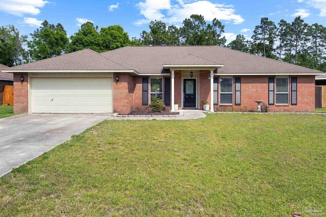ranch-style home featuring an attached garage, brick siding, driveway, and a front yard