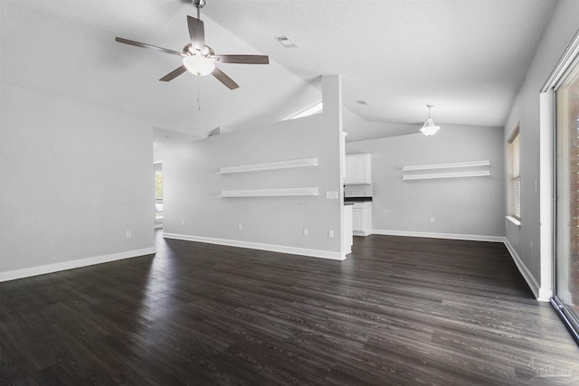unfurnished living room featuring vaulted ceiling, visible vents, a ceiling fan, dark wood-type flooring, and baseboards