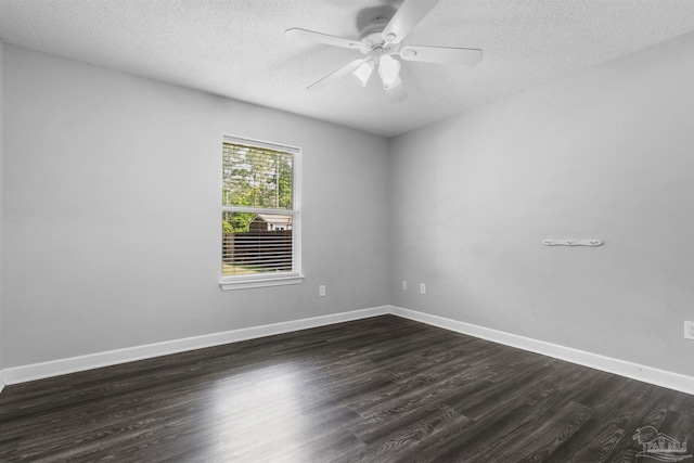 spare room with a ceiling fan, baseboards, a textured ceiling, and dark wood-type flooring