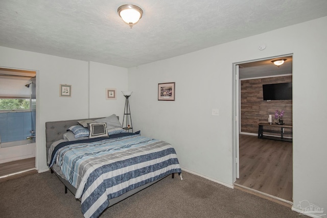 carpeted bedroom featuring wooden walls and a textured ceiling