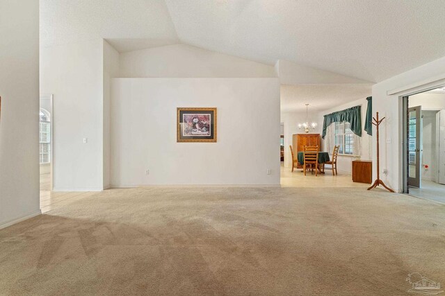 spare room featuring dark colored carpet and a textured ceiling