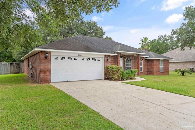 ranch-style house featuring driveway, fence, a front yard, a garage, and brick siding