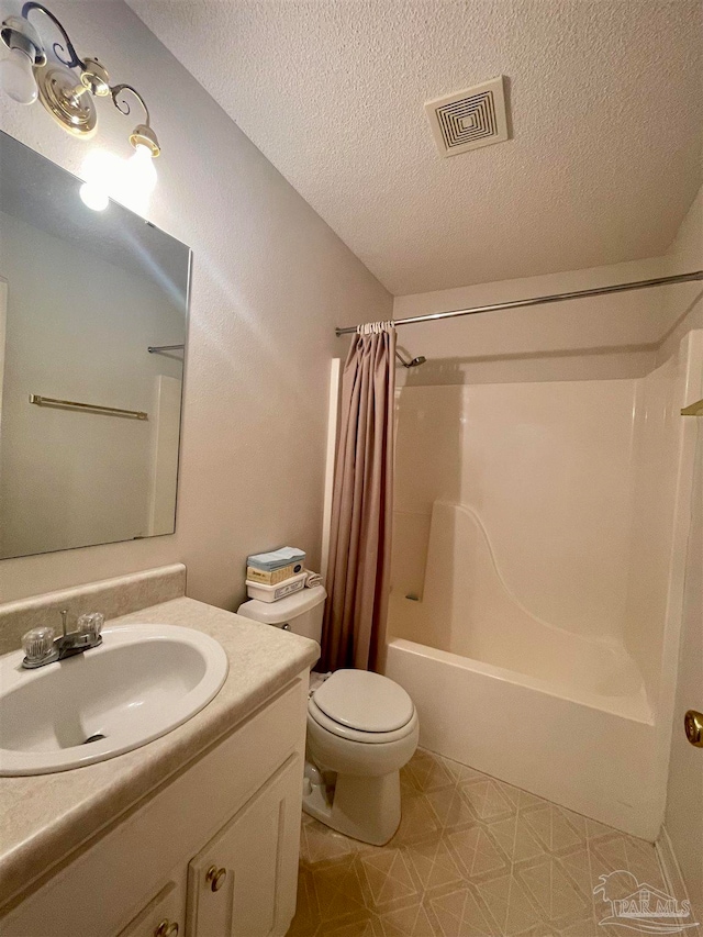 full bathroom featuring vanity, a textured ceiling, shower / tub combo, and toilet