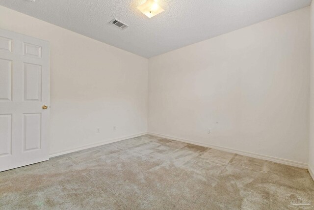 bathroom featuring a textured ceiling, vanity, toilet, and walk in shower