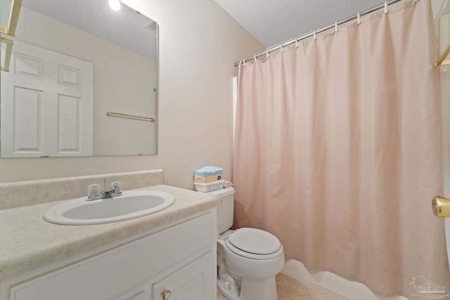 full bathroom with vanity, toilet, and a textured ceiling