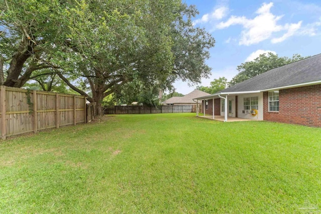 view of yard with a patio area and a fenced backyard