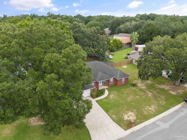 birds eye view of property featuring a view of trees