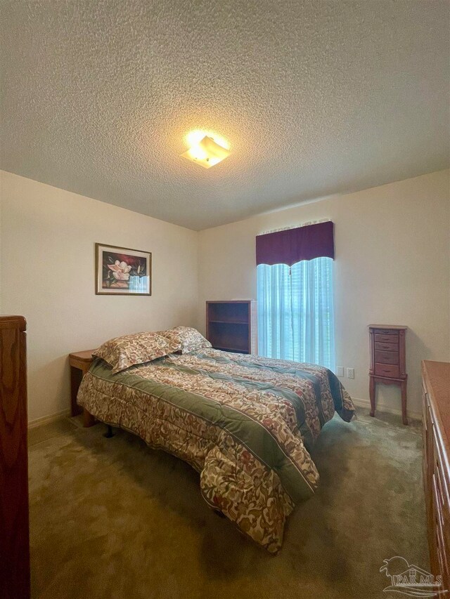 carpeted bedroom with a textured ceiling