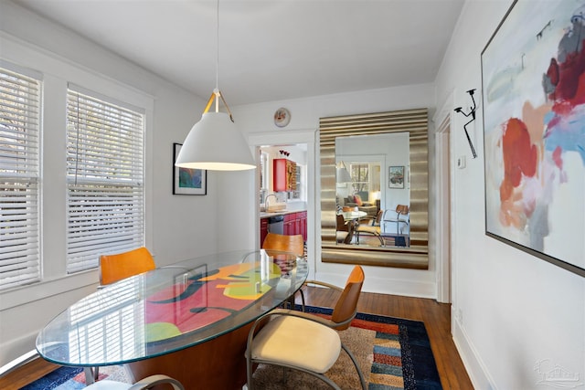 dining room with baseboards and wood finished floors