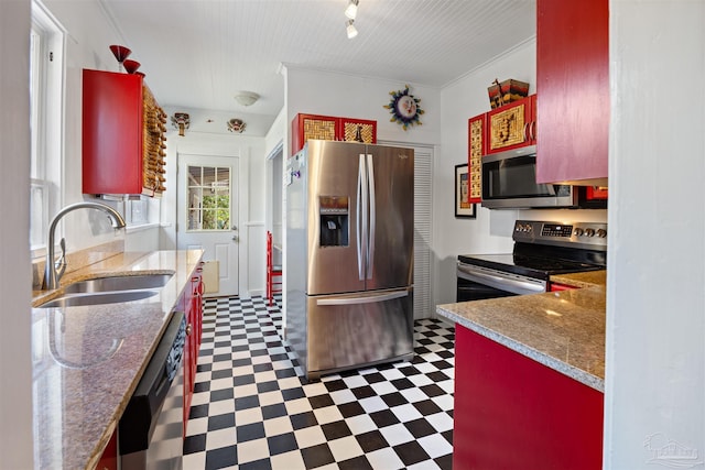 kitchen with crown molding, rail lighting, tile patterned floors, stainless steel appliances, and a sink