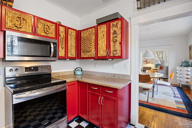 kitchen with ornamental molding, wood finished floors, and stainless steel appliances