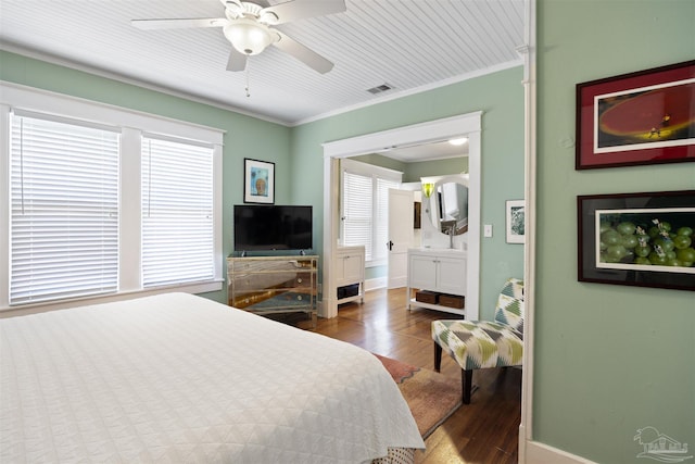 bedroom with visible vents, crown molding, baseboards, wood finished floors, and a ceiling fan