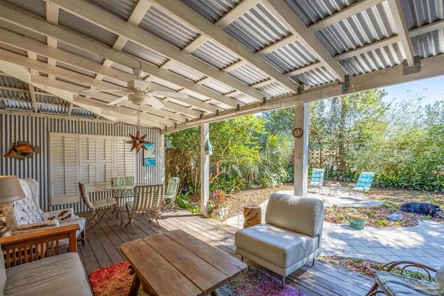 deck with outdoor dining space and a ceiling fan