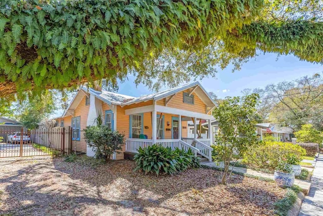 view of front facade with a porch and fence