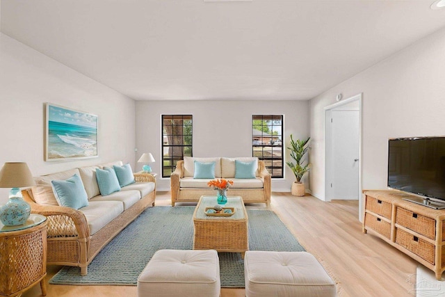 living area featuring light wood finished floors and baseboards