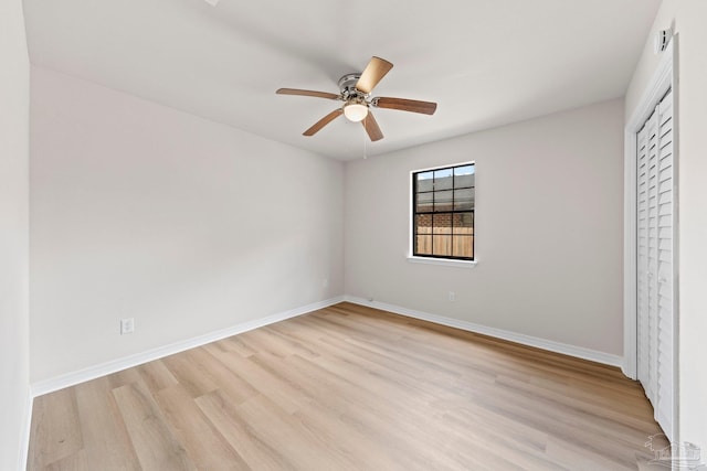 unfurnished bedroom featuring a closet, a ceiling fan, baseboards, and light wood-style floors