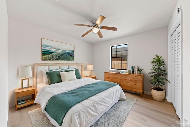 bedroom with light wood finished floors and a ceiling fan