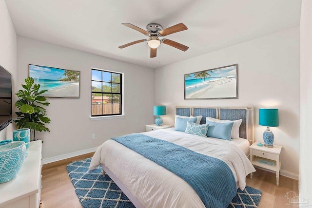 bedroom featuring a ceiling fan, wood finished floors, and baseboards