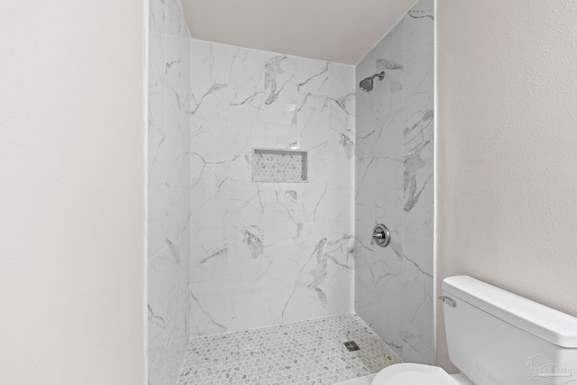 full bath with toilet and a stall shower