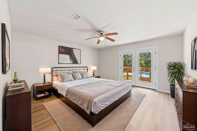 bedroom featuring visible vents, access to outside, french doors, and light wood-type flooring