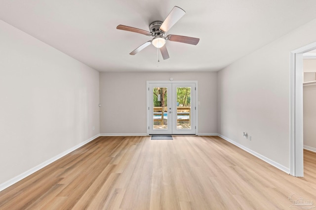 unfurnished room with ceiling fan, baseboards, french doors, and light wood-style floors