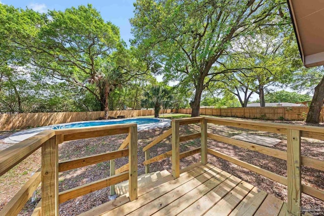 wooden deck featuring a fenced backyard and a fenced in pool
