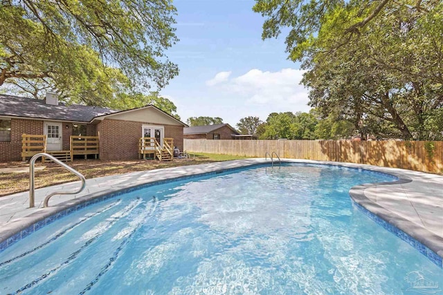 view of pool with fence, french doors, and a fenced in pool