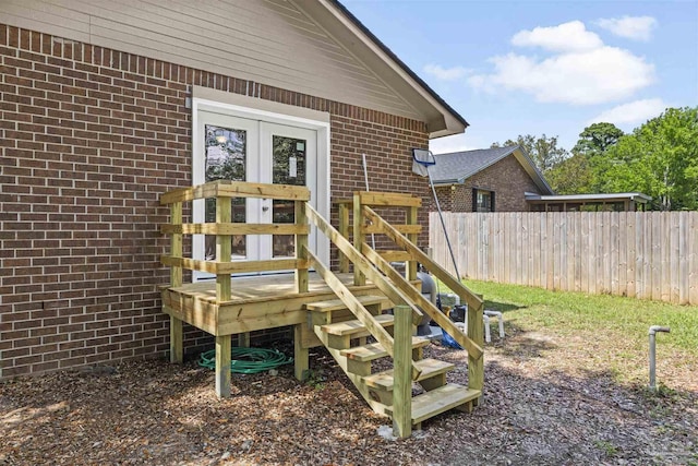 exterior space featuring fence and brick siding