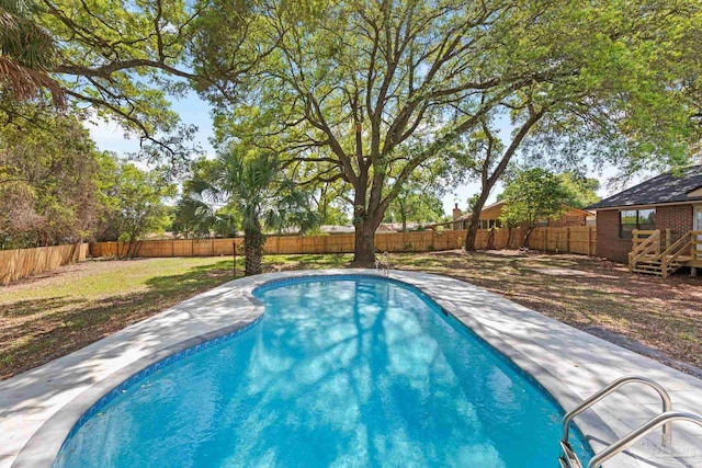 view of pool with a fenced in pool, a lawn, and a fenced backyard
