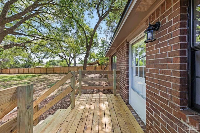 wooden terrace featuring fence
