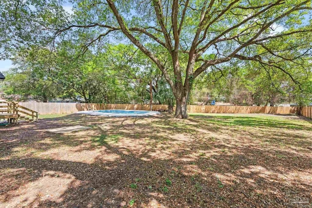 view of yard featuring a fenced in pool and a fenced backyard