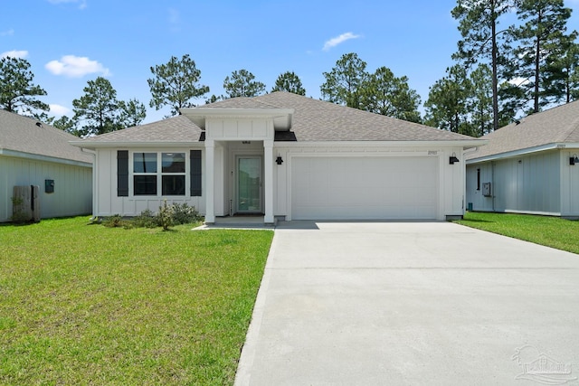 10985 Blacktail Loop, Pensacola, FL 32526 - view of front facade with board and batten siding, an attached garage, a shingled roof, driveway, and a front yard
