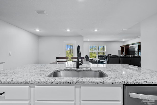 10985 Blacktail Loop, Pensacola, FL 32526 - kitchen with a sink, white cabinetry, stainless steel dishwasher, light stone counters, and recessed lighting