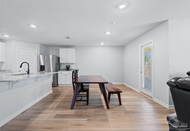 10985 Blacktail Loop, Pensacola, FL 32526 - dining area featuring recessed lighting, light wood-type flooring, baseboards, and a textured ceiling