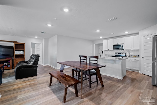 10985 Blacktail Loop, Pensacola, FL 32526 - dining space featuring light wood-style floors, recessed lighting, and baseboards