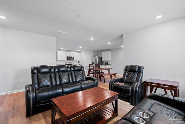 10985 Blacktail Loop, Pensacola, FL 32526 - living room with light wood-type flooring, recessed lighting, and baseboards